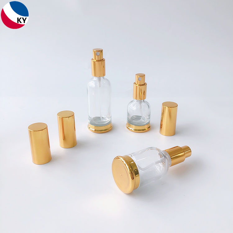 Luxury 15ml 30ml 50ml Round Gold Shoulder High Quality Clear Glass Pump Bottle with Gold Sprayer Pump